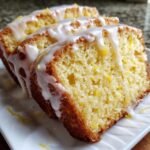Close-up of three moist slices of lemon pound cake topped with thick white lemon glaze.