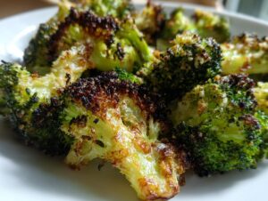 Close-up image of perfectly roasted broccoli florets showing crispy, slightly charred edges and bright green interiors.