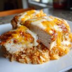Cross-section of Fiesta Lime Chicken breast topped with melted white and cheddar cheese, served over seasoned rice.