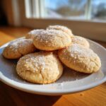 A stack of delicious, soft sugar cookies generously topped with coarse sparkling sugar crystals.