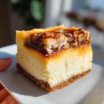 A close-up of a perfect square slice of creamy butterscotch lush dessert with a graham cracker crust and pecan topping.